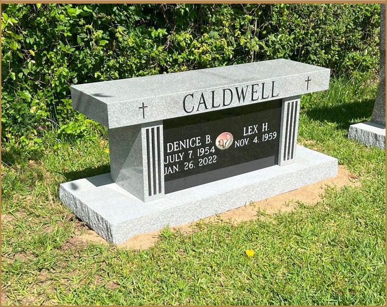 A granite memorial bench lettered CALDWELL